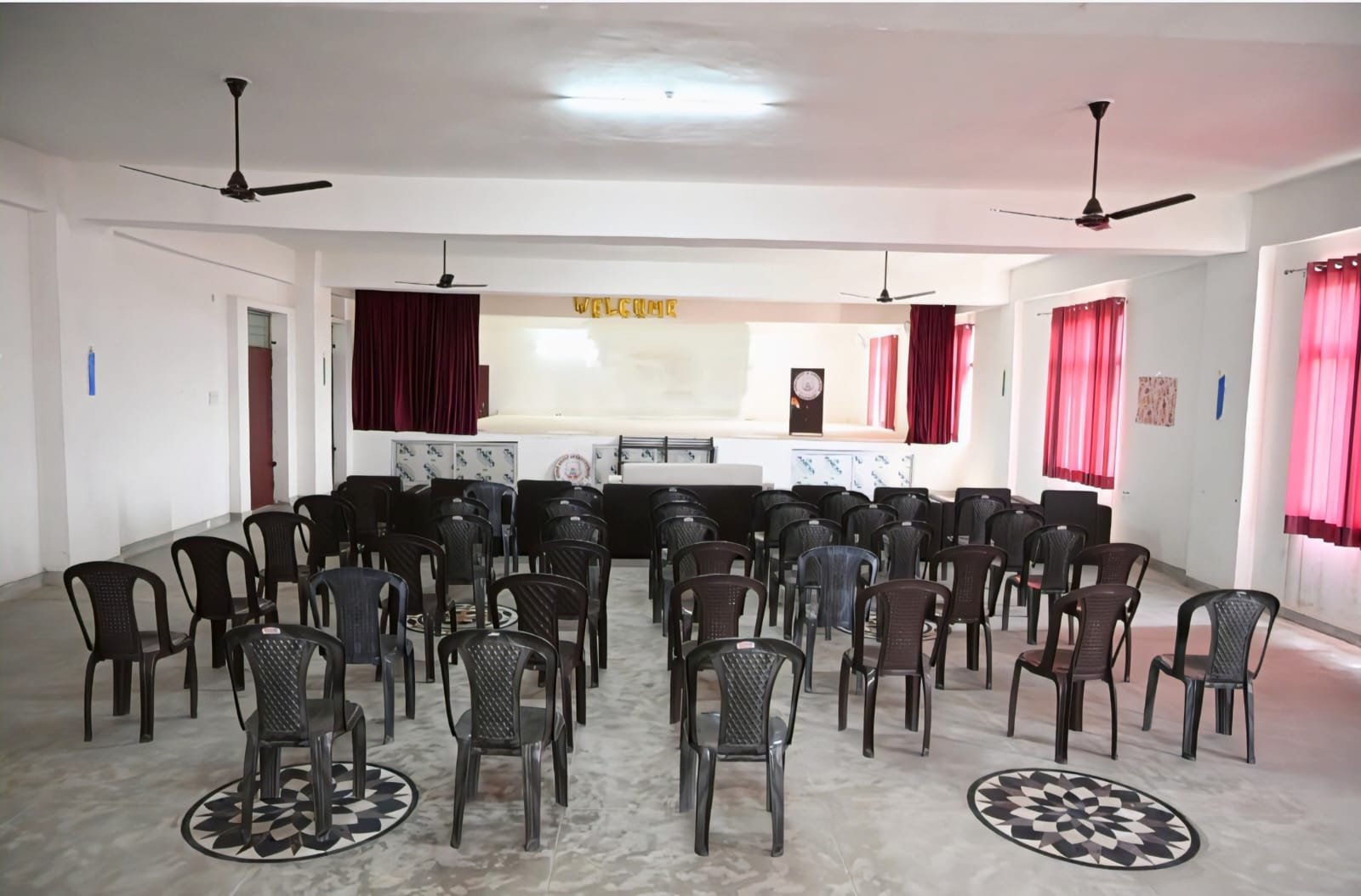 Seminar hall with arranged chairs at an Ayurvedic college in UP for student training and events.